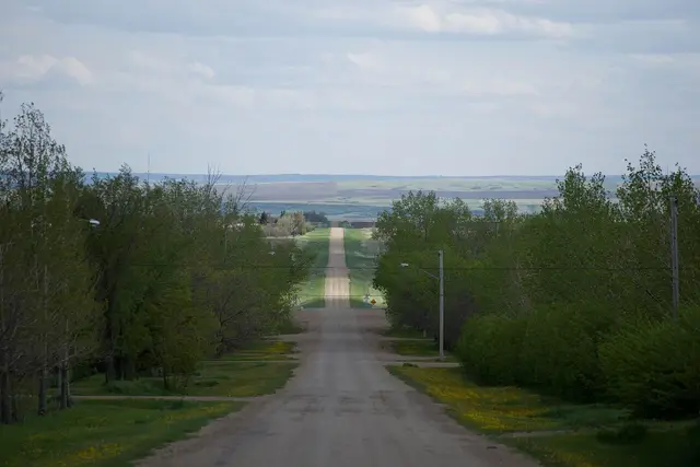 Gravel road leading out over the prairie